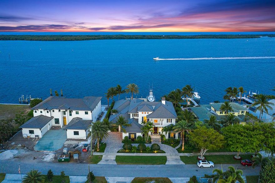 This waterfront estate designed by Randall Stofft and built by renowned builder Turtle Beach Construction is the definition of refined luxury living in one of the most desirable North Palm Beach neighborhoods. Stunning sunrises and sunsets over the wide water pour through oversized windows throughout the home, while its location across from MacArthur State Park offers nature views from all vantage points.  Immediately upon entering the grand two-story foyer, you will find an abundance of high-end features, such as the elegant Capiz shell chandelier, coffered ceilings, and custom millwork all of which add charm and sophistication to this magnificent home.  The welcoming foyer leads you directly into the bright airy living room with its exceptional wide water views, grand fireplace and adjacent formal dining room, complete with temperature-controlled walk-in wine cellar. The great room with wet bar and billiard table provides plenty of space to entertain in style, and opens to the gourmet kitchen, fit for even the most discerning of chefs. Replete with Wolf, Sub-Zero, Bosch and Miele-- top of the line brand appliances, built-in cabinetry with coffee/espresso maker, a center island, and breakfast nook, the expansive kitchen area is also the perfect setting for more intimate gatherings and meals. Upstairs, the master ensuite is a grand escape from the rest of the home with views of the water from its covered balcony and a spa-like master bath with stunning marble countertops, and soaking tub.  Also upstairs are the 2nd and 3rd bedroom suites with additional living room space, as well as a complete fitness center with state-of-the-art equipment. Step out to the rear veranda and find an exquisite infinity saltwater-heated pool, spa, and a built-in kitchen and bar. The covered seating area looking out to intercoastal waters is the perfect place to spend an evening outdoors. The property also has a 2-slip dock with boat lifts; perfect for housing watercraft, whether it's for taking in a sunset cruise or enjoying a day of sport fishing. There is no fixed bridge and the Palm Beach Inlet is only minutes by boat. With many other unique features included, proximity to Lakeside Park and the newly renovated North Palm Beach Country Club, this home is Florida waterfront living at its finest.