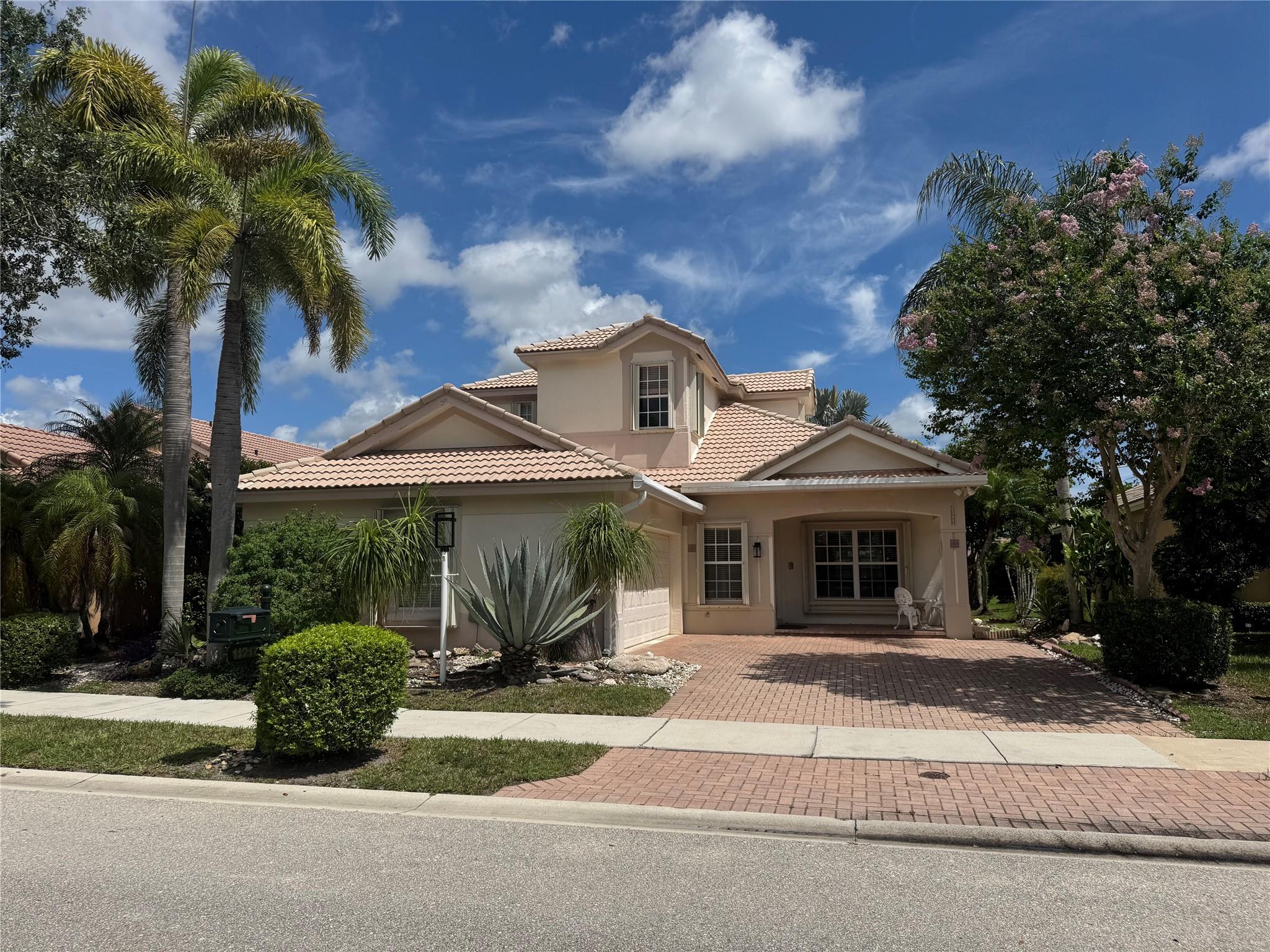 Come and explore this beautiful 4-bedroom, 3-bath pool home with 2 car side entry garage in Parkland Isles. Perfectly located in former builder model row just steps away from the clubhouse and community amenities. This spacious home features soaring ceilings, two newer A/C systems (2024), a beautifully remodeled pool (2021), and accordion hurricane shutters. Relax and entertain while taking in the serene lake views from your backyard oasis. HOA fees include Xfinity cable & internet, and ADT alarm system monitoring. This is your chance to own one of the most sought-after homes in the magnificent community of Parkland Isles located in the heart of west Parkland and centrally located between the schools.