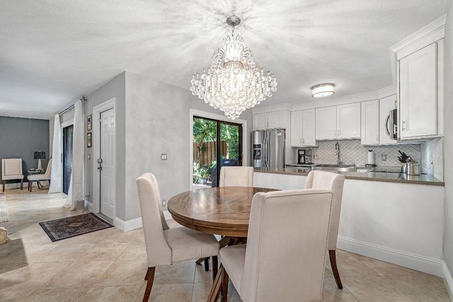 Home Sweet Home! Absolutely beautiful, move-in ready, updated townhome in the heart of Delray! Brand new kitchen with shaker style white cabinetry,  quartz countertops, custom back splash, farm style sink, and new Samsung stainless steel appliances. The living room is open, cozy and overlooks the tropical courtyard. It even boasts a gorgeous wet bar to entertain. Upstairs there are 2 master size bedrooms with private beautifully updated Italian porcelain bathrooms and balcony overlooking the courtyard. No matter which room you are in, this home makes you feel like you are in your very own oasis. This community is just minutes away from I95, shops, dining and lifestyle of Atlantic Ave, and beaches of Delray! Dining Room chandelier does no convey. Come see it before it is gone!