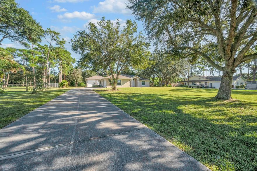 Bring Your TOYS, ALL of them! Enjoy Country Living, with all the Modern Amenities of Underground Utilities, High Speed Internet, Close Proximity to Beaches, Downtown, Highways & Whole House Generator. This 3 Bedroom 2 Bath CBS Home is peacefully nestled within the coveted neighborhood of Hidden Pines on 1 Acre of property. This homestead appeals to Business Owners, Car Enthusiasts & Families looking for a great neighborhood to set roots. Recently renovated, this Open Concept floor plan boasts a kitchen featuring a wall oven/microwave, cooktop, stone counters, large pantry, sprawling living room, Flex Area that can be utilized as a Office/Playroom/Den & Large Owners Suite, Split Plan, 500 Gallon Propane tank, 2023 Roof & Impact Windows/Doors.