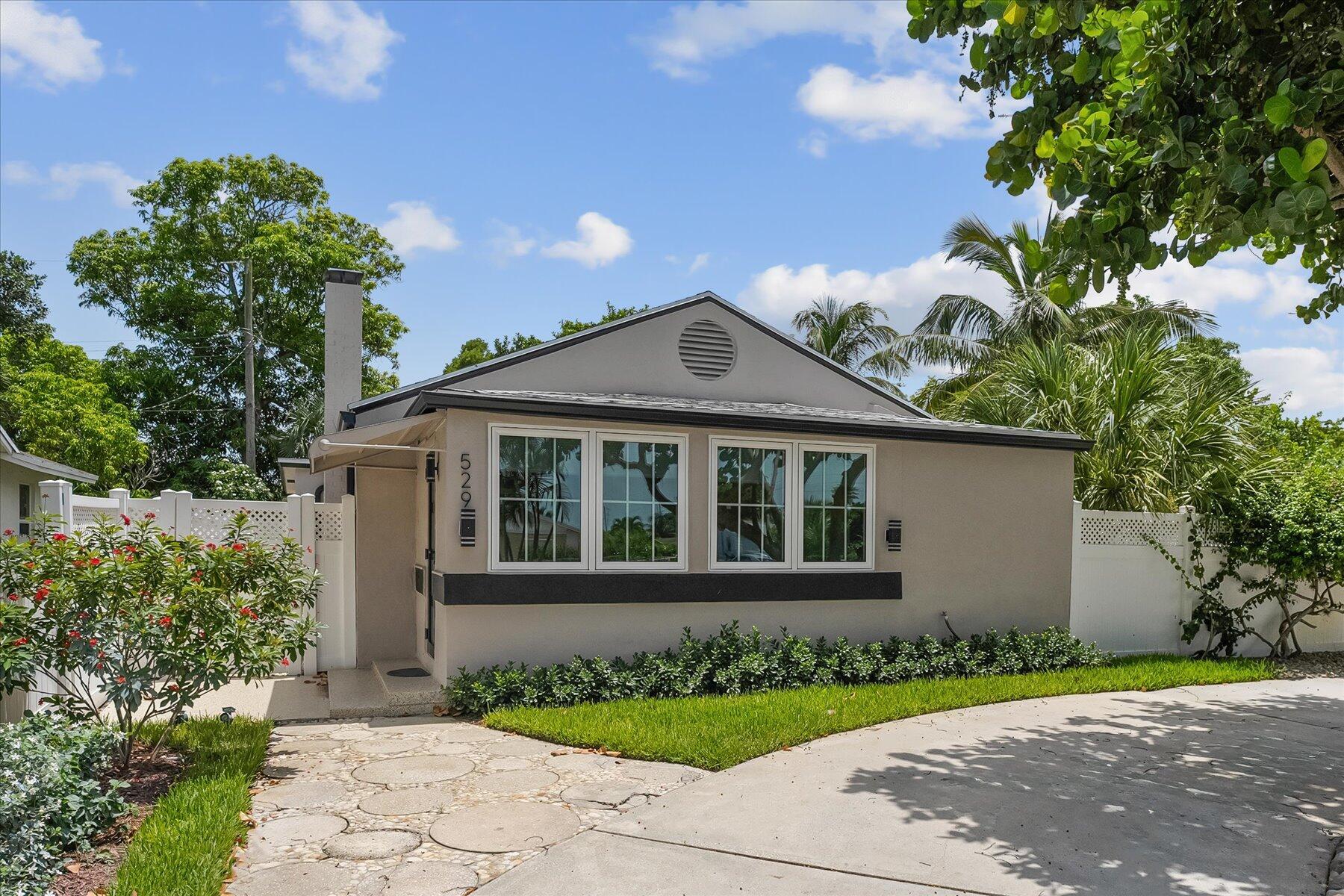 Be the first to lease this absolutely gorgeous & totally upgraded 2 bed/ 2 bath cottage dream home in the heart of Lake Worth Beach with the perfect blend of modern elegance & coastal convenience. The open floorplan is flooded with natural light and adorned with many high-end finishes. The kitchen is a chef's delight with top-of-the-line stainless appliances, sleek quartz countertops and ample storage space. The adjacent dining area is perfect for both intimate meals or entertaining. Enjoy the inviting living room complete with working fireplace or relax and host outdoor gatherings in the meticulously landscaped & serene back yard. The primary bedroom boasts a spa-like ensuite with a luxurious shower and dual vanities.