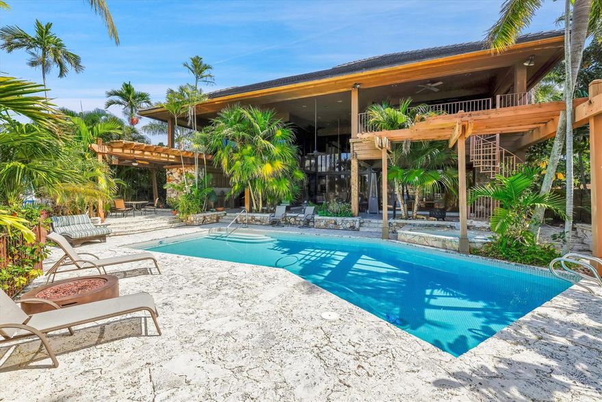 Magnificent custom built estate with direct views of the Intracoastal waterway. Located in the most desirable neighborhood by the beach, Sea Ranch Lakes. Soaring 22' ceilings and custom millwork welcome you into this very unique 4 bedroom, 5.5 bath home plus office. Spacious open living area features floor to ceiling windows and gas fireplace. Formal+ casual dining areas. 1st floor master suite with sitting area, luxurious bath, +2 huge walk in closets. Second level offers a comfortable loft room + 2 bedrooms, one with open balcony to enjoy spectacular water views. Fabulous covered patio and multiple entertaining areas surround the pool. 85' dock. This 24 hour man gated community has it's own police force, private beach, and clubhouse. Close to Lauderdale By The Sea restaurants and shops.