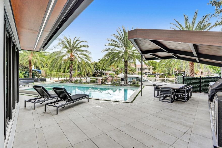 Captivating Ultra Modern Estate in the prestigious man gated Bay Colony is a true architectural masterpiece. With a bright opened floor-plan, 35 FT ceilings, expansive windows & skylights. This is the ultimate dream home featuring 6 beds, 7 baths, executive office, custom Italian kitchen with Miele & Sub Zero Appliances, gym, club room, home theater, 3 car garage, glass enclosed elevator, pool, covered outdoor kitchen, and a 89 feet dock on a deep water basin with easy access to the Intracoastal. This estate is fully automated with lighting, sound, & security creating a luxurious experience. Spacious master suite with an ethereal master bathroom with a huge free floating tub , skylights, and his and hers dressing rooms. Every detail in this home is high end and as beautiful as can be.