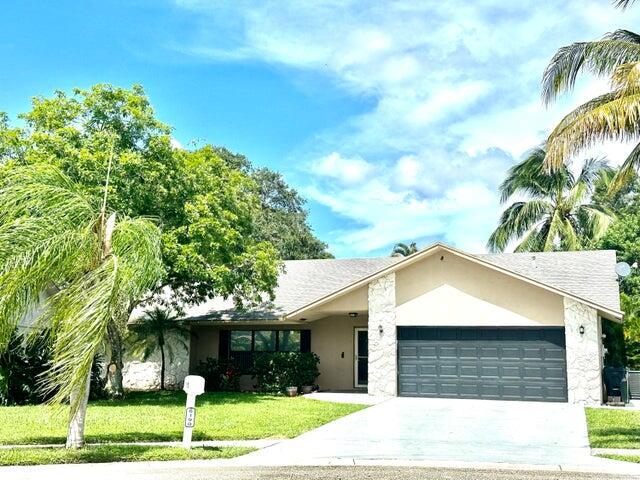 Lovely home situated on an oversized fully fenced private, lushly landscaped lot with awesome curb appeal ! Numerous upgraded features thruout: Tile, wood & laminate flooring. Nicely updated kitchen has granite, wood raised panel cabinetry w/crown molding. Upgraded appliance & a gas stove. Luxurious primary suite w/wood floors & lrg extra bonus sitting rm/office. Primary bath with beautiful finishes H & H sinks, step in clear glass shower, designer tiles. There's a huge paver covered & dome screened patio with an inviting lap pool. Spacious Living, dining, family & breakfast rooms give plenty of room to spread out & enjoy this tropical retreat. Spit bedroom plan with two bedroom & a full bath on the guest wing. Rent includes yard & pool service. Don't miss this ready to move into home.