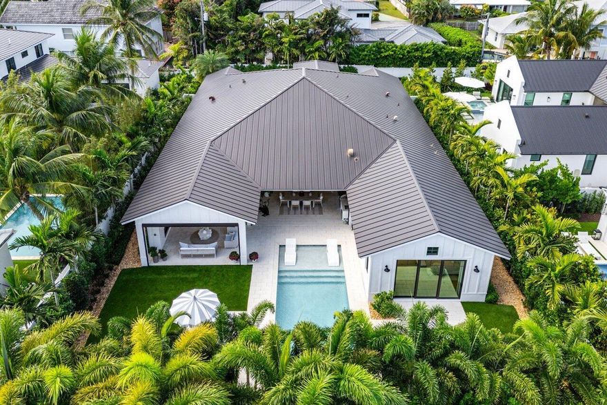 Nestled in the prestigious Lake Ida neighborhood of Delray Beach, 10 NW 17th Street stands as a perfect example of how to enjoy maximalist luxury living without sacrificing privacy and comfort. With cavernous high ceilings in its living spaces that are complimented by a design style that blends sleek modernity with comforting farmhouse touches, this home offers vivid elegance across 4 bedrooms, 4.1 bathrooms, and 5100 total sq ft of thoughtfully designed space on an expansive 14,806 square foot lot. Created by Bella Homes, the residence offers a perfect blend of sophistication and innovation, with cutting edge features and smart home technology integrated throughout all within a few blocks of the famed Atlantic Avenue and all that Delray Beach has to offer. The open-concept layout