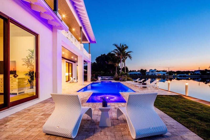 This stunning brand new waterfront home located at 70 Spoonbill Road, Manalapan offers picturesque views with a coastal contemporary design. Boasting 115 feet of waterfrontage on Manatee Cove with private dock and direct ocean access, the property invites South Florida Luxury Living at its best. The flexible floor plan features over 7,200 total square feet, five bedrooms, living room with fireplace, open kitchen, two master suites, elevator, generator, three-car garage and custom finishes. Enjoy outdoor living with covered loggia, summer kitchen, open terrace for lounging and pool with dual sun shelves and custom water feature. This property also has private beach access and membership to La Coquille Club at the celebrated Eau Palm Beach Resort & Spa. This property is sure to please. Situated on a prime Manalapan parcel with 115 feet of direct waterfrontage and 150 feet of depth, this brand new quality built home showcases the phenomenal water views of Manatee Cove and the Intracoastal beyond. The seaside Town of Manalapan offers its residents unparalleled privacy with its own town hall, library, police department with security patrol and a strict development policy to protect the area's natural beauty. The centralized Palm Beach County location provides close proximity to the boutiques, eateries and cultural activities in Palm Beach and Delray Beach. Boaters will appreciate the nearby inlet for quick trips to the open seas while jet setters will enjoy having several private airports and three international airports conveniently accessible via Interstate 95.

The curb appeal is enhanced by the clean and manicured landscape and decorative driveway with ample parking for residents and guests alike. The double glass door entry provides the first glimpse of the light and bright interior with impressive views of the grounds, pool and waterway thanks to floor-to-ceiling glass sliders. The living room has a fireplace, volume paneled tray ceilings and flows effortlessly to the kitchen and dining room. The chef's kitchen has a sleek design with large island, Thermador appliances including gas range, lots of cabinets and counter space and easy access to the formal dining room with Wine Guardian temperature controlled glass wine cellar and bar with Miele cappuccino machine. The office is located off the entryway across from the elevator and stairway.

The south wing hallway leads to the three-car garage for easy access to the kitchen, pantry and first floor laundry room with full-size washer and dryer. The hallway also leads to the massage room which could serve as an office, a full bath with exterior door and pathway leading to the pool and a gym which could be a bedroom with closets and sliders to the terrace and pool. The first floor master wing is located on the north wing and features a morning bar, two large walk-in closets, dual vanities, two water closets, soaking tub and custom glass walk-in shower. The master bedroom has wood paneled ceiling and sliding glass doors to the pool and waterway beyond. 

At the top of the stairway there is an expansive landing, morning bar and second floor laundry room. The VIP suite features gorgeous water views, sliders that open to the expansive covered balcony, two large closets, linen closet and master bath with dual vanities, glass shower and soaking tub. There are two additional en suite guest bedrooms with closets and access to covered balconies.

The flexible floor plan of this coastal contemporary residence allows the indoors to effortlessly transition to the outdoors for private retreats and festive entertaining. The spacious covered loggia has a summer kitchen with grill and plenty of room for outdoor living area and dining. The sparkling heated pool has dual sun shelves and water features that arc across. The manicured green spaces perfectly frame the decorative poolside terrace with outdoor shower and walking path to cabana bath. With 115 feet of waterfrontage on Manatee Cove and a private 50-foot dock, boating is a breeze with ocean access via the nearby inlet. Ready to go to the beach or schedule a spa day? Residents of Manalapan have private beach access and gratis membership to La Coquille Club at the nearby Eau Palm Beach Resort & Spa. 

Quality built with custom finishes, this brand new home has 5,593 square feet under air; 7,253 total square feet; five bedrooms including a first floor master suite and second floor VIP suite and five full baths. Other luxury features include three air conditioning zones with linear air diffusers; wood floors; custom trim; central vacuum; generator; impact windows and doors; elevator; custom lighting on stairway; interior frosted glass doors; under-stair closet; fenced yard and three-car garage with exterior door that leads to walking path and grounds.

Come enjoy all that South Florida has to offer in this luxurious brand new property with stunning water views and plenty of room for residents and guests alike!