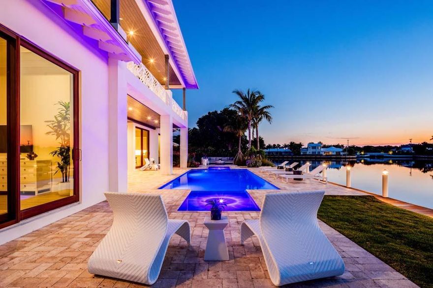 This stunning brand new waterfront home located at 70 Spoonbill Road, Manalapan offers picturesque views with a coastal contemporary design. Boasting 115 feet of waterfrontage on Manatee Cove with private dock and direct ocean access, the property invites South Florida Luxury Living at its best. The flexible floor plan features over 7,200 total square feet, five bedrooms, living room with fireplace, open kitchen, two master suites, elevator, generator, three-car garage and custom finishes. Enjoy outdoor living with covered loggia, summer kitchen, open terrace for lounging and pool with dual sun shelves and custom water feature. This property also has private beach access and membership to La Coquille Club at the celebrated Eau Palm Beach Resort & Spa. This property is sure to please.