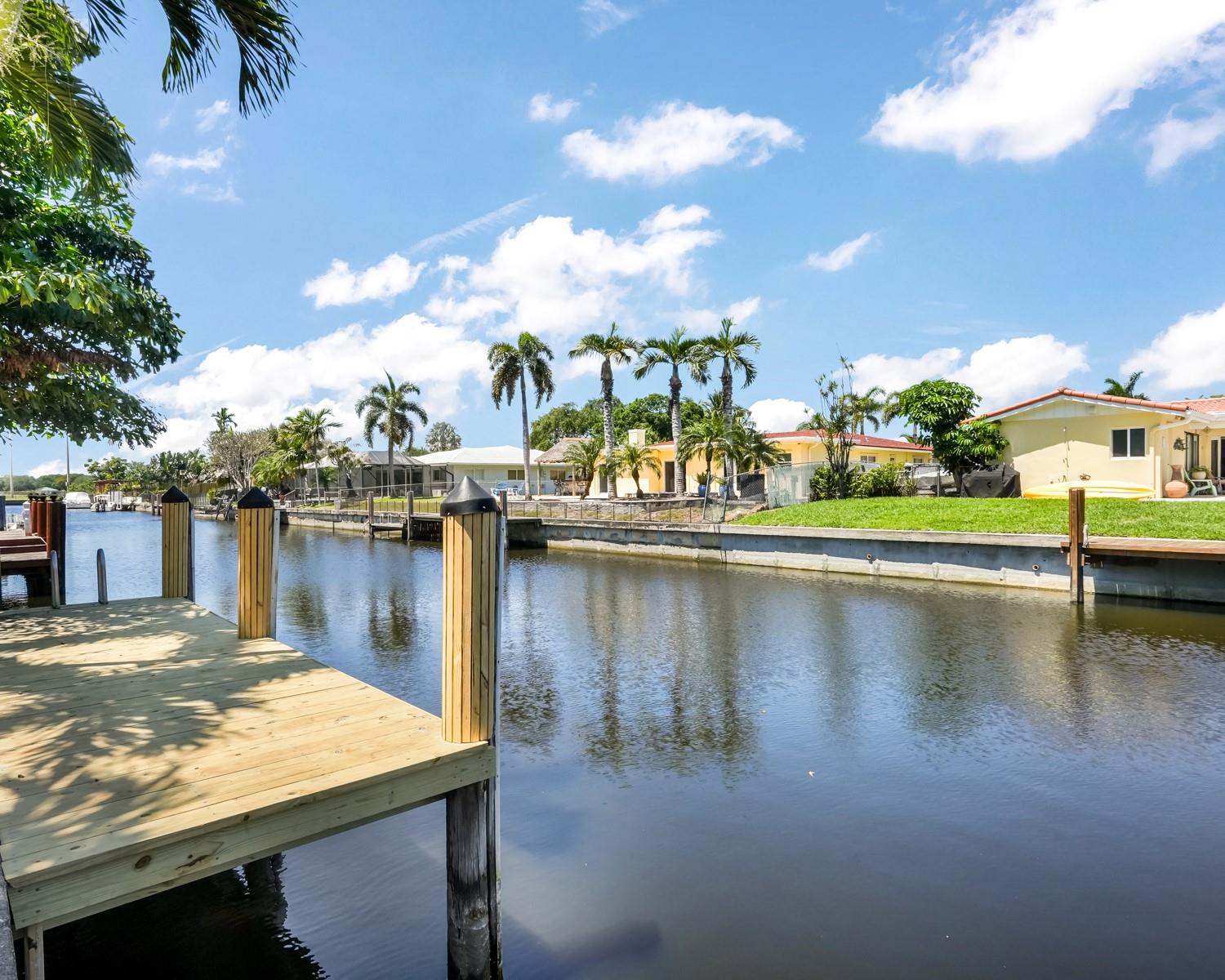 Waterfront Gem in Plantation Isles. Seller willing to contribute credits at closing with acceptable offer. Beautifully remodeled home with ocean access, private boat dock, and pool in the heart of Plantation. The open-concept layout features a stunning kitchen with quartz countertops, shaker cabinets, farmhouse sinks, oversized island, double ovens, and a walk-in pantry with wine cooler. Spacious master suite with sitting area, generous guest rooms, and stylish bathrooms with dual sinks. Impact windows and doors, plantation shutters, and an enclosed patio add comfort and style. The large backyard offers room for an RV or boat trailer, and the circular driveway easily fits four cars. Move-in ready and perfect for Florida living!