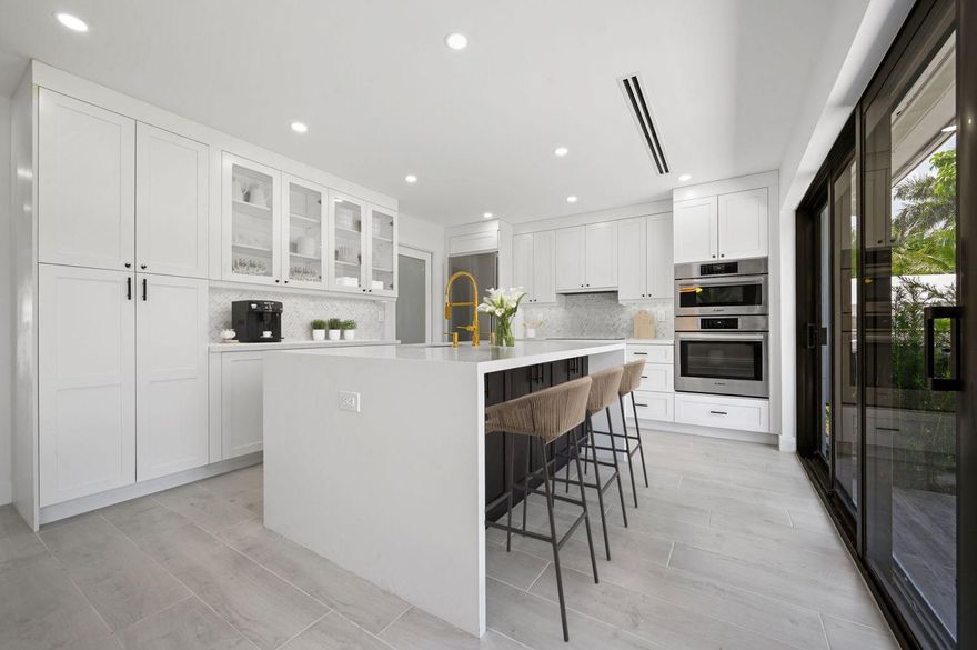 This is a Must-See! Mid-century charm loaded with modern luxuries, offering you the best of both worlds. This home has been completely renovated with high-end finishes & fixtures! Step inside to discover wood-like ceramic floors throughout, complementing the open-concept design. The custom kitchen's top-notch appliances make this home an entertainer’s dream. Looking to extend your living space beyond the confines of the interior? Look no further than the two sets of triple sliders that lead to the expansive backyard with plenty of room for a pool! Embrace the Florida lifestyle as you entertain family and friends or create your personal sanctuary. You can rest easy knowing that the Electrical, Plumbing, and HVAC systems were all redone in 2023. (Impact windows and sliders throughout)