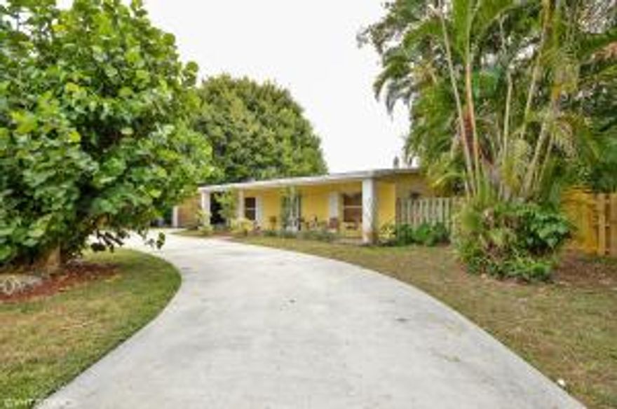 Magnificent Lake Clarke Shores Parcel! This lovely 3 bedroom 2.5 bath residence sits on a huge lot with great waterfront space on the lake.  Enjoy boating, picnicking and entertaining in this spacious home with almost 2,400 sq. ft., carport, open porch and pool. Breathtaking great room has vaulted ceilings, Herpel tile floors, French doors to outside patio, pool and dock. Situated an a wide part of the Lake, this home offers loads of space, great charm, and is ready for your updates! Huge kitchen with tiled counter tops, room for island and lots of storage. A home that will inspire your inner decorating muses. Along with the fantastic lot, is the remarkable location. Close to I-95, the airport, downtown, beaches and on a gorgeous lake make this a very desirable home.