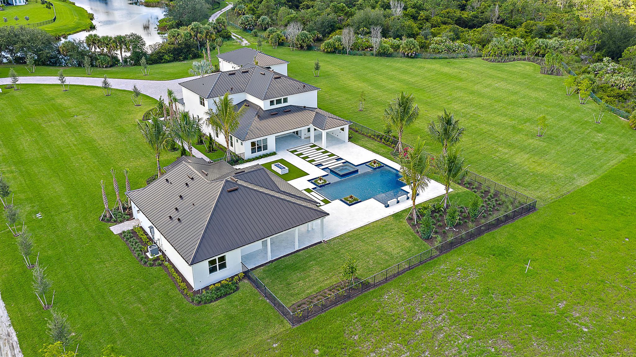 Bridgewater's crown jewel - a rare 4.61-acre estate offering unmatched privacy, luxury, and lifestyle in the heart of Jupiter, east of I-95.Set on one of the largest and most private homesites in the nearly sold-out Bridgewater community, this exceptional property features brand-new construction, a separate guest house, detached garage, and a resort-style saltwater pool -- all surrounded by lush landscape and endless potential. With only one neighboring home and direct adjacency to Jonathan Dickinson State Park, this estate delivers the ultimate blend of elegance, convenience, and natural tranquility.