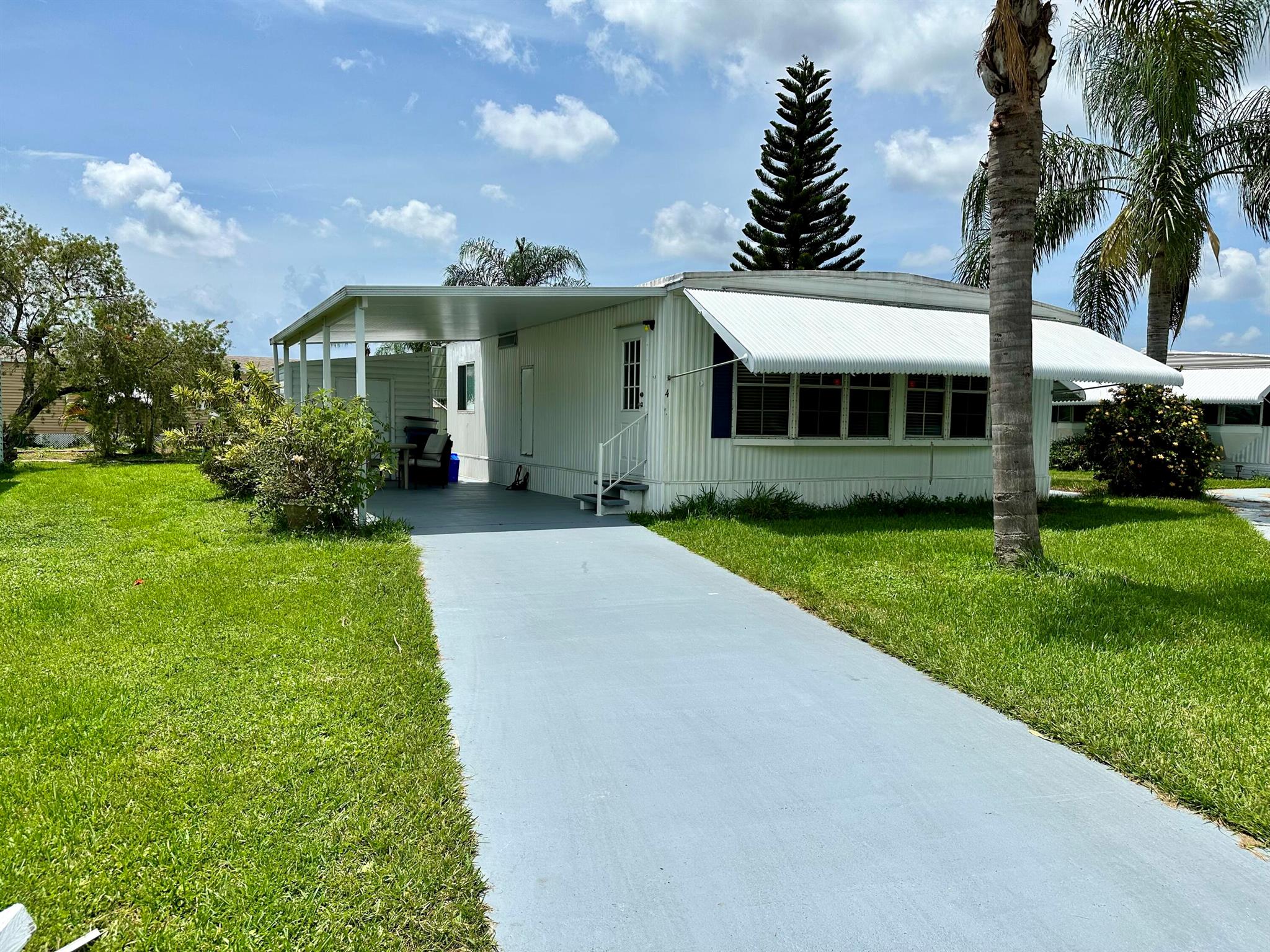 A cozy home that has been updated for you, with a patio off the living room slider. The shed comes with a full size washer & dryer. Pictures tell more of the story. There is no HOA fee, as your $722.06 monthly land lease fee pays for everything including your lawn maintenance, trash removal, and community amenities. This home is tucked away into a private community, yet within a few miles of the beaches, hospitals, restaurants and shopping. You must be approved by the park to purchase a home.