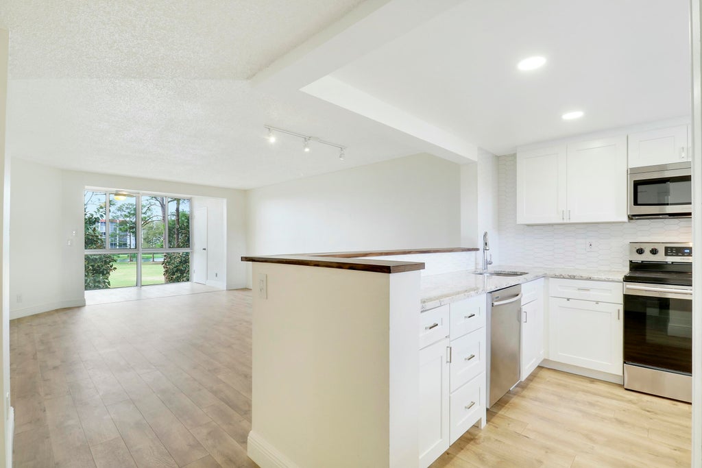 Photo of 3755 Via Poinciana #309, Lake Worth, FL 33467 (MLS # R11077928)