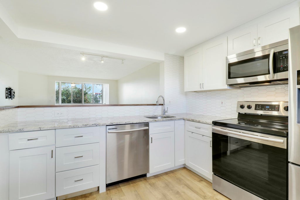 Photo of 3755 Via Poinciana #309, Lake Worth, FL 33467 (MLS # R11077928)
