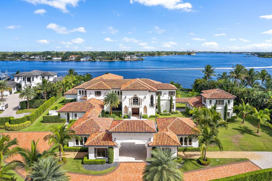 Welcome to Villa Real, a Breathtaking estate of incomparable elegance sited on the largest assemblage of Waterfront land currently available in Jupiter: Just under 4 acres  with 254' of stunning wide water views.  Offering the Ultimate in  privacy + security, this palatial residence boasts an imposing 18,302 sq. ft.   
 A gated 640' palm treed drive leads to this stunning abode.  Masterfully built in 2016 by award winning Anderson Moore using only the finest materials, this home is a true classic modern Palazzo.  Interiors  include a soaring 2 story entry, stunning wood + marble works and bespoke fixtures, creating a magical ambiance.  Finely curated furnishings provide an exquisite move in ready haven. The hub of the home is the grand kitchen and family room - a sprawling area of luxury + comfort.  The professional ASID award winning kitchen is designed to stylish perfection while offering the finest in functionality.  Adjoining massive family room is outfitted with Automated sliding doors opening to the grand loggia, blending indoors + out.  Inside, a private elevator + grand staircase leads to the second level and upper gallery.  The Owner's suite is an oasis of unparalleled luxury, from the grand hall entry with morning bar to the opulent marble bath and dual wardrobe rooms.  A private loggia offers exquisite serenity.  An additional 5 spacious bedrooms with ensuite baths + large closets are in the main house.  A separate 1,800 SF guest house has 2 additional ensuite bedrooms.  Villa Real offers every amenity of comfort + style, from the dramatic double level pool to huge waterfront loggias w/ fireplace and summer kitchen as well as a home theatre.  Enchanting grounds with endless water views + Ocean breezes and a 107' dock along the Loxahatchee River provides a protected and easy path to the Jupiter Ocean Inlet.   A beautiful life awaits you...