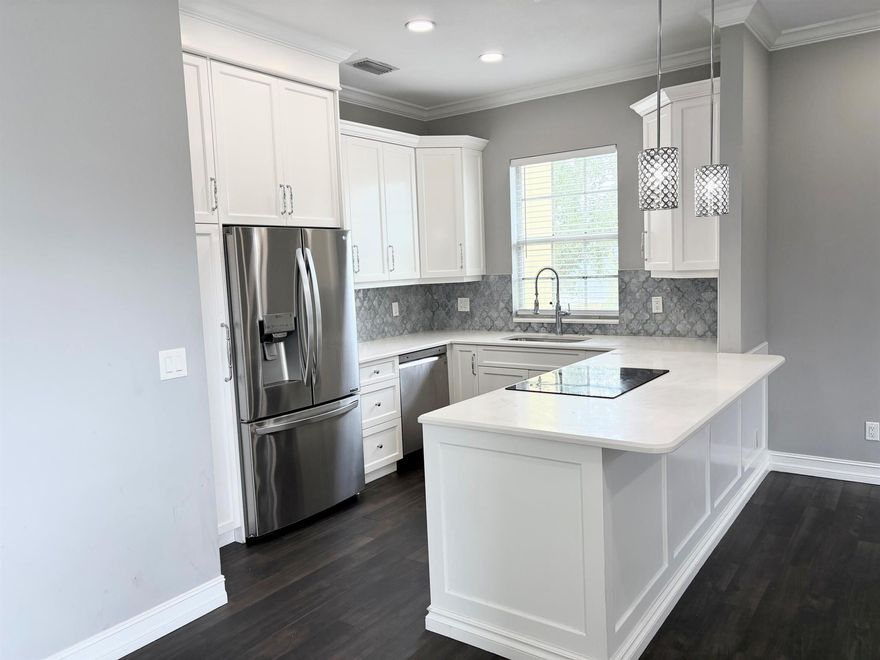 Completely renovated 2/2 with garage in the heart of Tradition. Walking  distance to Publix, target, restaurants.   Wood floors throughout, quartz in kitchen and bathrooms, SS appliances, upgraded fixtures, custom bathrooms with large soaking tub in master with makeup vanity.  Don't miss out on this beautiful condo in Tradition.