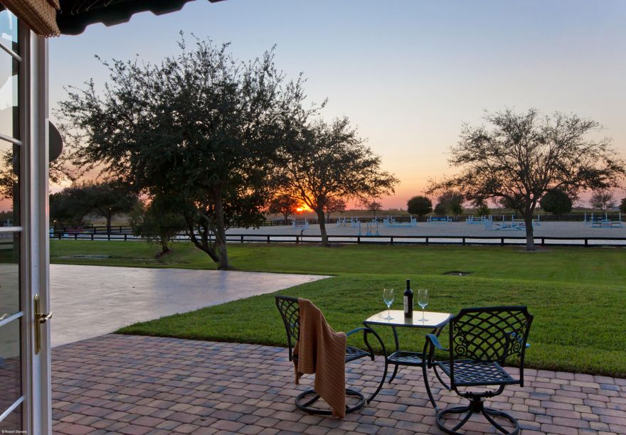 10.95 acre equestrian estate home in a gated Palm Beach Point, hacking distance to Grand Prix Village & WEF Showgounds. 12 Stall barn(can have up to 24). Spacious main residence w/3 bedroom suites, all opening to the heated pool & patio. Beautifully appointed with custom kitchen cabinetry, oversized butler's pantry, wide-plank wood floors, granite & marble finishes, wood beamed ceilings & a fireplace. The European courtyard Style stable was completely updated in 2014 - all new stall fronts, doors, brick paver aisle ways & center courtyard, exterior window shutters and 3 new wash racks. Above the barn are two, 1BR/1Bth grooms apartments with a shared balcony. There is an additional CBS constructed 100' x 60' outbuilding - easily converts to a custom designed center-aisle barn. This out-building could also house a work shop, RV, work out room or offer additional space for the car collector. It currently has additional stalls using portable European style systems. There is a beautiful 300' X 200' riding arena with great drainage and footing. The property lends its self perfectly for constructing a covered riding arena. There are 10 large grass paddocks, 2 of which are run-outs from stalls and a round pen. The property has separate entrances for the residence and stables. The private cul-de-sac location on the bridle path, is priceless. There are endless possibilities for this one of a kind property, its a must see to appreciate. It currently produces over $220,000 a year in gross income. The entire exterior of the house, stable and outbuilding were repainted in 2014. The property would easily be approved for up to 24 stalls. If you're looking for wonderful amenities, privacy, and a great location in close proximity to the show this is the property to see! A simple 1/2 Mile hack by bridle path to Grand Prix Village and WEF