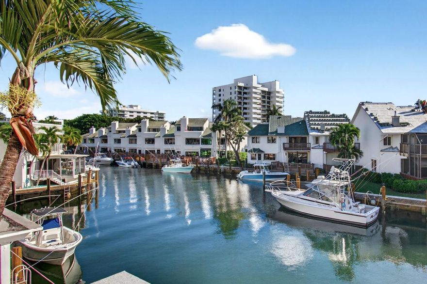 LIVE AT THE BEACH, just steps to your private beach access & Deepwater Dockage. This waterfront townhome features hardwood flooring, stainless appliances, wine cooler, hardwood cabinets, granite counters & breakfast bar. Exterior attributes include 22' common dock, spacious screened porch with picturesque water views & upstairs open balcony. Boca Cove is a PET FRIENDLY community and offers resort amenities. I.E., newly remodeled clubhouse w/kitchen, billiards, gym, BBQ grill, community pool, gated private beach access, bike room, guest day dock, and gazebo. A remarkable walk-to-the beach location.