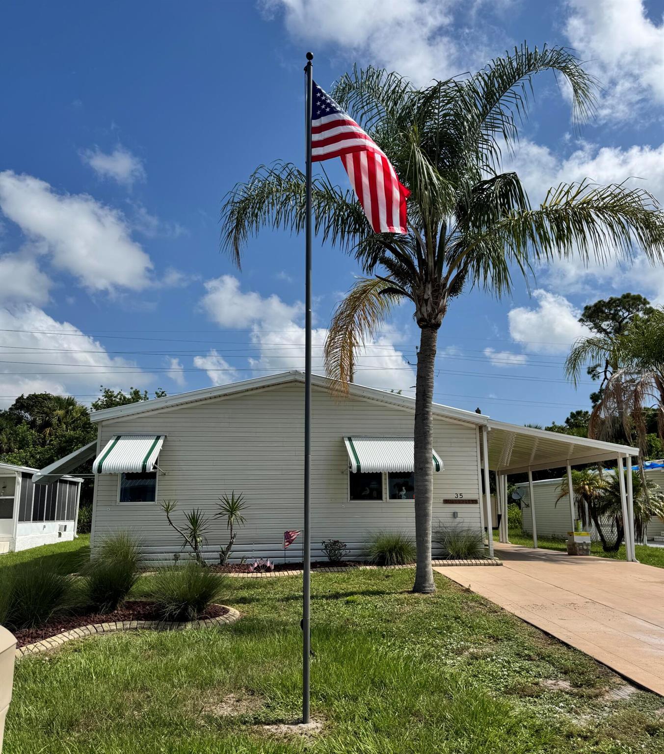 Lovely 3 bedroom 2 bath home in the desirable 55+Spanish Lakes Country Club Village community. House sits on quiet cal da sac and backs up to private wooded area. Split floor plan. Large great room and kitchen. Laundry inside home. Screened lanai off back of home as well as a shed. New metal roof 2025, New car port 2025. Water heater 2023. New shutters. Home is being sold furnished. Lawn care, trash removal and golf included in lot rent.18 hole golf course,2 pools, tennis, pickleball, bocce ball, shuffle board and much more. Must See!