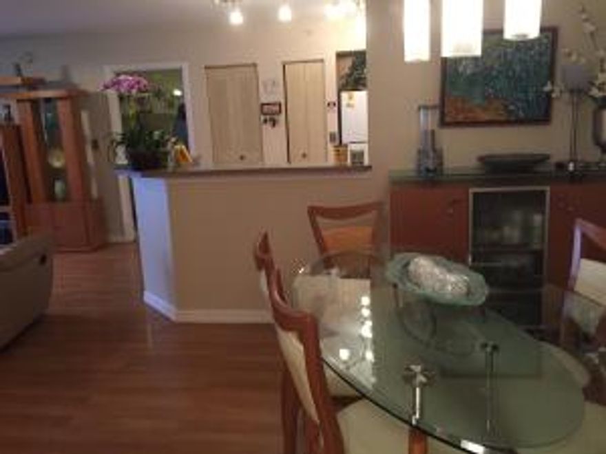 Amazing FIRST FLOOR, corner unit with covered patio area, great for entertaining. This split floor plan,with plenty of room for the family and friends, is  equipped with engineered hardwood throughout. Cook up a wonderful meal in the large, centralized kitchen with a unique backsplash. The subdivision has amazing amenities, including the pool, exercise room and club house. Take a peek! You won't want to miss this unit.