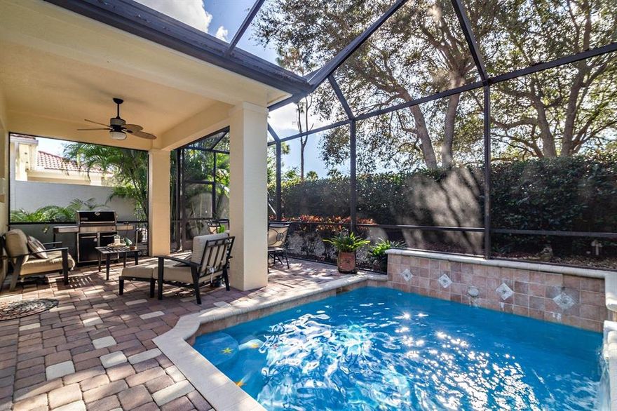 Total privacy from this pristine 3 bedroom plus office expanded El Prado model offering a sought after open floorpan.  Wonderful amenities in this manned, gated community such as a fitness center, tennis courts & beautiful community pool & clubhouse  without the high fees of a country club! Incredibly well maintained easy to move into home with light neutral appointments/upgrades including crown & picture moldings, plantation shutters, remote control electric shades, lots of built ins (including speakers & closets), neutral tile floors on the diagonal, solid wood doors, double gas oven and granite counters. Beautiful landscaping , surrounded by stunning oak trees. Fully screened patio and a heated salt system pool and spa. Hurricane shutters & tinted windows lowering insurance &energy cost