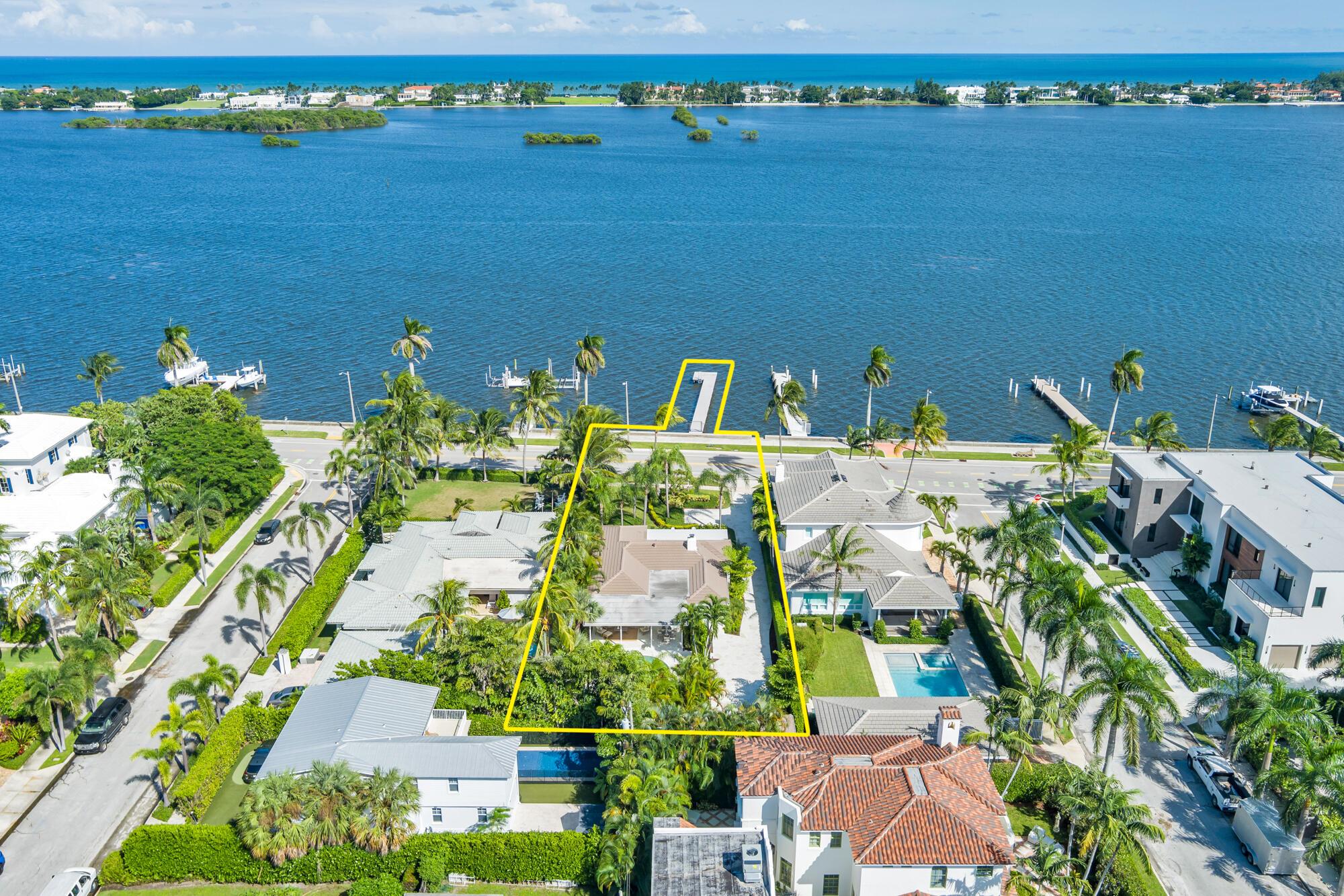 OWNER FINANCING AVAILABLE. Step into waterfront living at its finest with this pristine Flagler Drive waterfront home. Enjoy breathtaking Intracoastal views and over 62 feet of waterfront on this approx 9800 sqft lot.  A 100-foot private dock makes this a boater's dream--just bring your boat and start cruising. Inside the main house you'll find 3 bedrooms, 2.5 baths, plus a bonus 1/1 separate guest accommodations, all wrapped in full hurricane impact windows and doors. Clean architectural lines are balanced with custom millwork and molding, giving the home a timeless elegance.  The newer roof, new HVAC, new appliances and thoughtful updates make this residence completely turnkey. Surrounded by lush, tropical landscaping, and a resort style heated pool and covered loggia, this