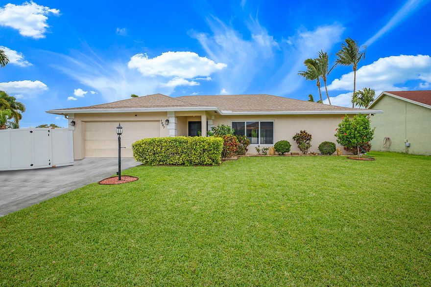 Located in desirable The Estates of Lake Clarke Shores, this beautifully maintained 4-bedroom, 2-bath pool home sits on a spacious corner lot and features a 2-car garage and excellent curb appeal. Inside, enjoy vaulted ceilings, hurricane impact windows and doors, LED lighting, upgraded fans, shiplap accents, and a fantastic split-bedroom floor plan ideal for comfortable living and entertaining. The semi-open living areas flow into a well-appointed kitchen with stainless steel appliances, range hood, ample cabinetry, and breakfast bar. The spacious primary suite offers pool access, a walk-in closet, and ensuite bath with dual sinks. Step outside to a screened patio and fully fenced backyard with a heated pool and plenty of space to relax or entertain. Additional highlights include a  tankless gas water heater, 4-ton Rheem A/C, generator plug, upgraded sprinkler system, and energy-efficient improvements. Low quarterly HOA includes tennis, pickleball, gazebo, and boat ramp access to Lake Osborne and Lake Ida. Convenient to shopping, dining, I-95, and the beaches. A fantastic opportunity to enjoy the best of South Florida living!