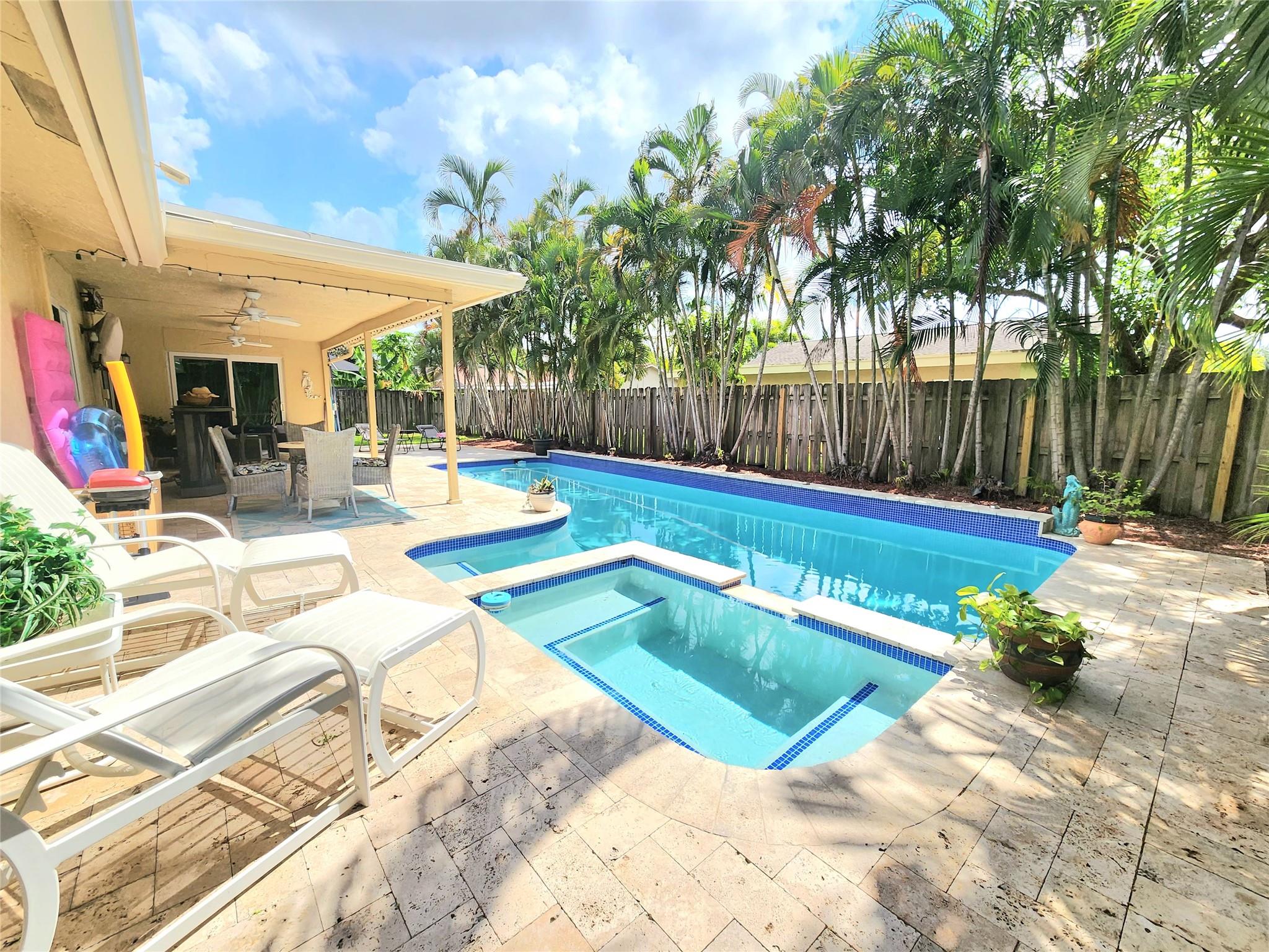 SHORT-TERM AVAILABLE JULY THROUGH JANUARY. This beautifully FURNISHED resort style property will make you feel comfortable in any room. Featuring a new kitchen fully equipped with modern appliances. The master bath has a jetted soaking tub and a walk-in shower. RELAX in the private large pool area which is a tropical oasis, complete with a whirlpool, new outdoor furniture, a bar, and a TV with fans, perfect serenity. Situated in a quiet neighborhood with a lovely waterfront park and within walking distance to stores, the home offers convenient access to the turnpike and from I-95. This home is move-in ready, just bring your linens and toothbrush.