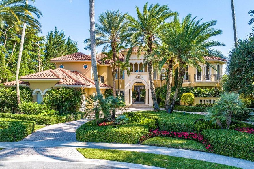 Introducing the pièce de résistance of the Polo Club, this two-story estate is a symphony of elegance and refinement. Boasting 8 bedrooms with an additional office and 9.5 baths, it stands as a testament to refined living. As you approach the home down the quaint cul-de-sac into the circular driveway, the distinguished 3 car plus golf cart garage commands attention. Walking through the grand doors, the foyer is accentuated by a magnificent wrought iron and stone staircase serving as a captivating centerpiece. Transitioning into the great room, you cannot help but take note of the impressive scale and magnitude of the interior. The expansive space is adorned with soaring ceilings, cascading natural light, a striking fireplace, and regal embellishments. Floor-to-ceiling windows offer > panoramic views of the private pool and patio with the gleaming lake behind. Adjacent, a sophisticated sit-down wet bar invites guests to indulge in luxurious entertainment. Offering a smooth transition into the grand dining room, a picturesque setting with verdant surroundings enhancing the ambiance. The gourmet kitchen, complemented by an attached large walk-in pantry, offers ample storage and endless culinary possibilities. Adjoining the kitchen, an eat-in dining space, and a living room provide great flow and ease of living. Outdoors, the backyard oasis beckons as the sweeping lake views cascade in the background. The covered verandah offers a lounging area, bar, and summer kitchen including a barbeque and a dining space. The entirety of the private pool features a custom mosaic tile surround, with a fountain and spillover spa to epitomize outdoor South Florida living. Back inside, the primary bedroom suite is a sanctuary unto itself, with a spacious retreat and double French doors accessing the covered patio. The lavish suite continues to feature dual walk-in closets, dual water closets, a sumptuous spa-like tub, and a statement walk-in shower. Just outside the primary suite is a private office for added convenience. Downstairs, two generously sized bedrooms include ensuite bathrooms and large closet space. Ascending the staircase, guests are greeted by a loft, offering respite and relaxation. Each of the five ensuite bedrooms on the upper level exudes its own unique charm, with one of them including a private balcony overlooking the scenic lakeside vista. In every aspect, this showpiece home is the epitome of elegance and style. It's located in the prestigious Vintage Oaks section of The Polo Club. Access to the world-class amenities of country club living is at your fingertips.