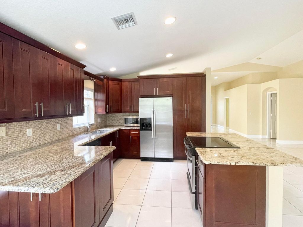 Photo of 2425 Pigeon Cay, West Palm Beach, FL 33411 (MLS # B26026671)
