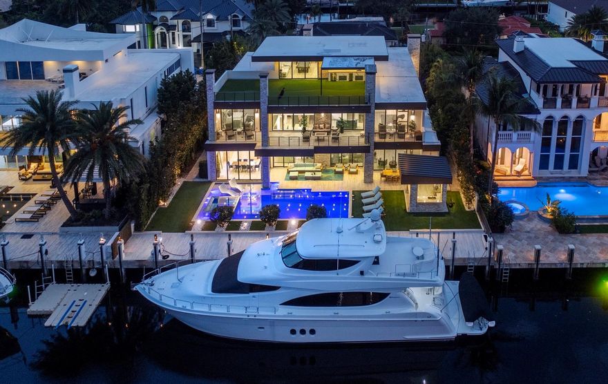Located in guard house secured Seven Isles, this exceptional FULLY FURNISHED custom deep water residence offers the very best of modern sophistication & ultimate entertainer's floorplan. Located on a premium oversized property with 103ft concrete dock.  Very best of Lutron home automation & security systems. Three level extraordinary floor plan includes elevator two primary suites (1st & 2nd level),Chef's kitchen, Subzero, Wolf, Hansgrohe & Toto, 350+ bottle wine cellar.  Expansive bedroom suites & additional entertaining amenities include 3 fireplaces, theater, office, gym, loft area plus sky lounge, roof top putting green - high quality custom finishes throughout set this home apart! 3 bay garage & resort style East facing pool & separate Summer kitchen. Must be seen to be appreciated!