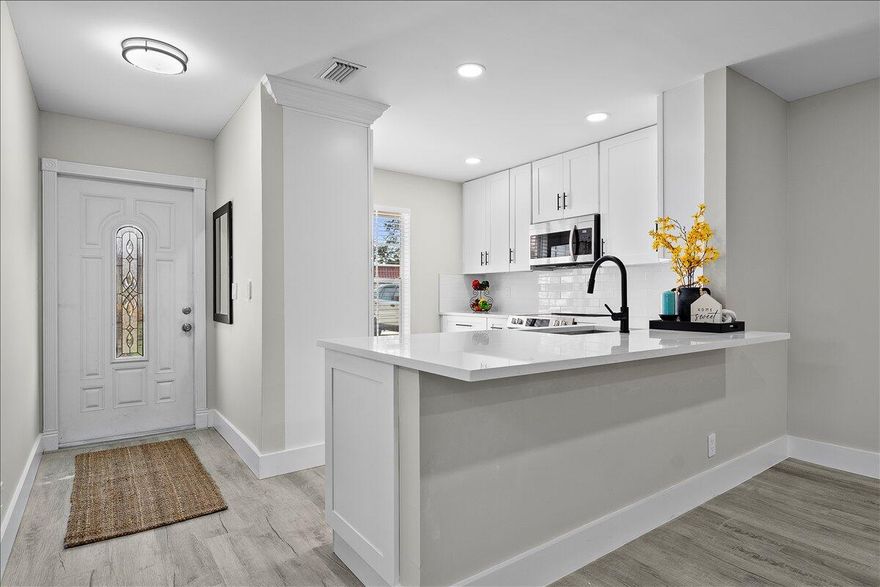 Stunning Fully Renovated 2-Bedroom, 2-Bath Villa in Covered Bridge - Pet-Friendly & Move-In Ready. Welcome to your ideal home in the heart of Covered Bridge, a highly sought-after 55+ community in Lake Worth! This beautifully updated 2-bedroom, 2-bathroom corner villa with lake views offers modern elegance and comfort, ensuring a hassle-free living experience. Upon entry, you'll be greeted by an open-concept design featuring brand-new luxury vinyl flooring, stylish barn doors, and designer finishes throughout. The custom gourmet kitchen is a chef's dream, showcasing new quartz countertops, high-end shaker cabinetry, and premium stainless steel appliances - perfect for both casual dining and entertaining. Both bedrooms are generously sized and filled with natural light, each offering