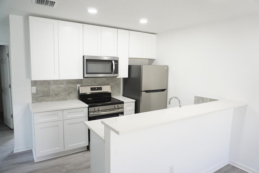 **BRAND NEW 3 BEDROOM 2 BATH UNIT, OPEN FLOOR PLAN, KITCHEN HAS QUARTZ COUNTERTOPS, NEW WHITE REAL WOOD MODERN CABINETS, BRAND NEW STAINLESS STEEL APPLIANCES, LUXURY PLANK FLOORING THROUGHOUT. NEW WASHER & DRYER