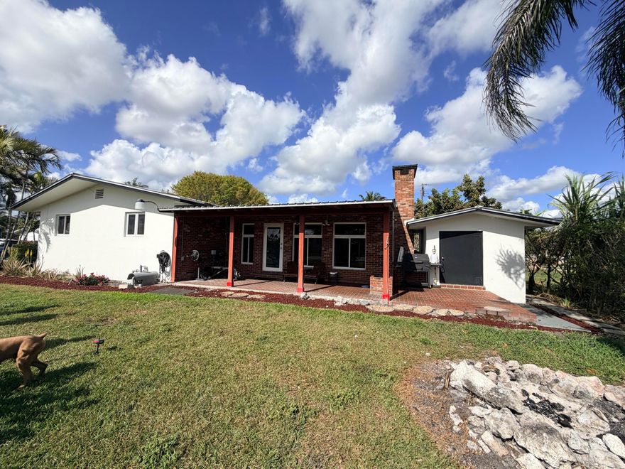 Welcome to this beautiful 4-bedroom, 3-bath home offering nearly 3,000 total square feet on a large corner lot in one of the area's most peaceful and family-friendly neighborhoods. Features include a durable metal roof, full impact windows and impact doors, updated porcelain tile flooring, and a bright kitchen with wood cabinets and granite countertops. The spacious layout offers the potential for a private in-law suite or an income-producing apartment with its own bedroom, bathroom, and living area—perfect to help offset the owner's mortgage. Ample parking with a carport and large driveway, plus a shed and generous outdoor space ideal for family gatherings. A perfect place to call home. 1hr distance to Miami,30min to west palm beach airport,restaurants, shopping centers&beautiful beaches