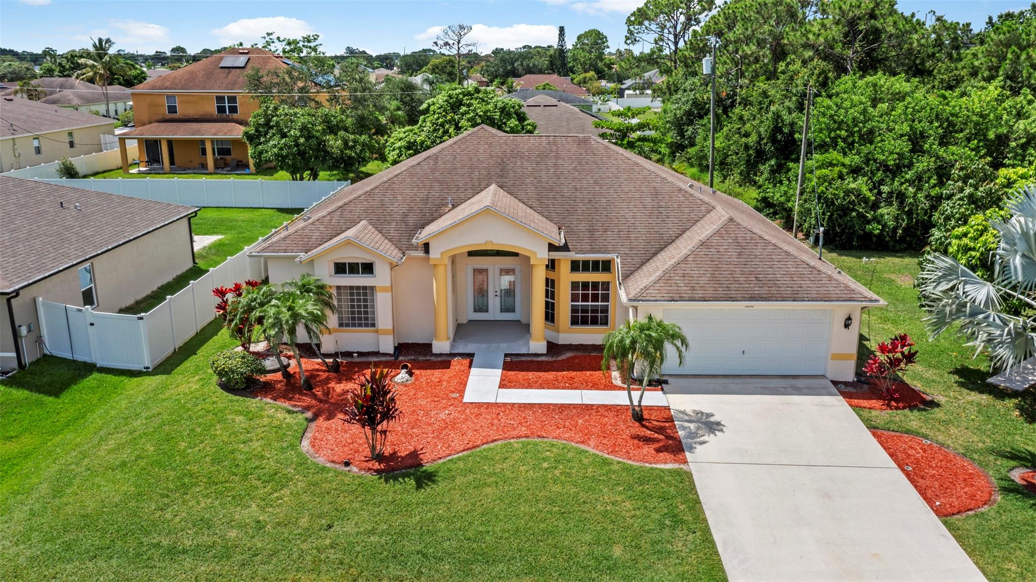 Don't miss this beautiful Model home with spacious 3-bedroom, 2-bath with a 2-car garage, ideally located in the heart of Port St. Lucie. This well-maintained property features a bright, open floor plan and a large kitchen complete with granite countertops, maple cabinetry, and plenty of space for cooking and entertaining. The expansive master suite includes volume tray ceilings, dual walk-in closets, and a luxurious en-suite bath with double vanities, a walk-in shower, and a relaxing soaking tub. Enjoy the best of Florida living in the oversized backyard—perfect for entertaining, gardening, or adding a pool. Mature fruit trees offer both charm and shade. Conveniently located near the Florida Turnpike and I-95.