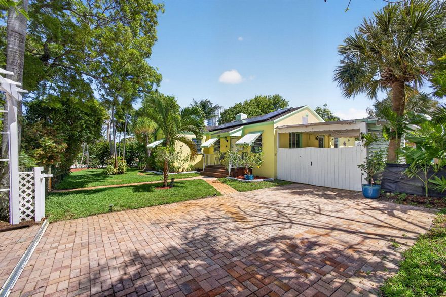 Don't miss this darling 2/2 CBS home sitting on a coveted corner double lot in the heart of Historical Northwood Harbor district in West Palm Beach!  Soak up the sun and the coastal breezes on your large private back deck in a lush setting featuring a variety of mature fruit trees, flowering plants and tropical foliage.  Back building features an outdoor shower, utility room and storage.  Entire property fenced in.  Ample parking within gate and street parking available as well.  Enjoy strolling over and along the intracoastal just a block away!  A short drive to the beaches and world famous snorkel trail at Phil Foster Park, Clematis Street, Palm Beach Island, shopping, fabulous dining, golf courses and the airport.  Solar panels recently installed.  NO HOA!   Dog park a short walk away along with 3 waterfront parks within 5 blocks.  Avocado, Mango, Dragonfruit, Banana, Lime and Lemon trees.