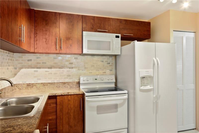BRIGHT & BEAUTIFUL...MOVE RIGHT IN! With Beautifully updated Kitchen and Bathrooms and freshly painted interior this condo is turn key. Features walk in Closets with built-in's, Tile throughout, Washer/Dryer in unit, 2 separate screened porches off living area and master bedroom (with roll down hurricane shutters)