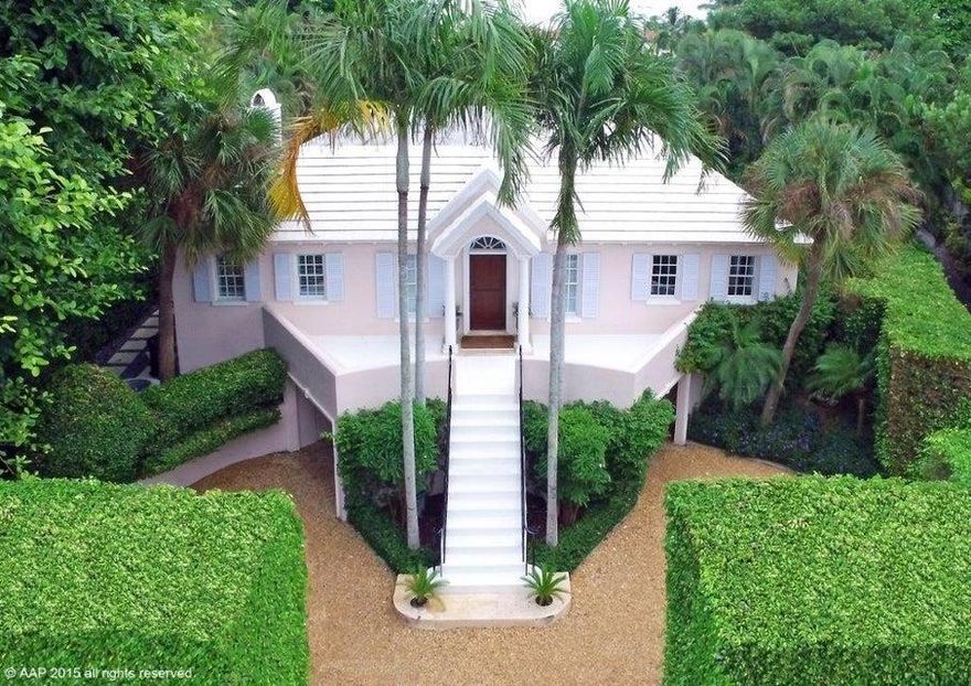 An ESTATE SECTION home is offered at a North End Price! Convenient to public beach & town; nestled among the grand estates, offering space and privacy. In move-in condition, new systems, sizeable garden & low upkeep costs. Formal living features a fireplace and dual French doors leading onto a large canopied loggia making the house perfect for entertaining in any weather. Impact doors, windows and/or shutters offer complete storm protection. Eat-in kitchen features SubZero refrigeration, 2 prep sinks w/disposals, 2 BOSCH dishwashers, 6-burner Thermador gas range,3 SubZero wine coolers and butler's pantry leading to the formal dining room with fireplace and tray ceiling. Covered parking for up to 2 cars, driveway parking for up to 4 cars and secluded parking for vendors.