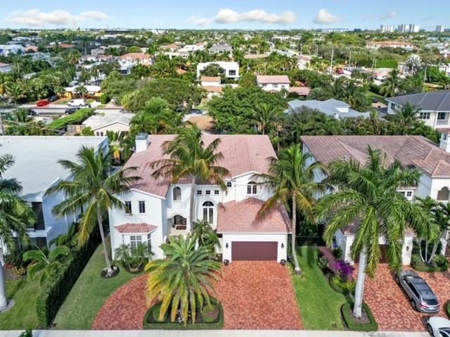 Unlock the downtown Boca experience with this timeless 5 bedroom, 5.5 bath pool plus 3 car garage residence. This treasured location is highly desirable with incredible walkability to all of the fabulous restaurants and shops of  Mizner Park, Royal Palm Plaza, Palmetto Park Rd, and the beach! With vaulted ceilings, the living room has an open and airy feel, fireplace, and French doors leading to the summer kitchen patio and pool with raised spa.  All bedrooms are ensuite and the master suite is complete with a balcony, wet bar, and his/her W/C and closets. Get in a good workout in your home gym (currently part of the 3rd car garage) before heading out for a fabulous dinner in vibrant downtown Boca! A perfect place to call home as a primary residence or use as a lovely vacation getaway!