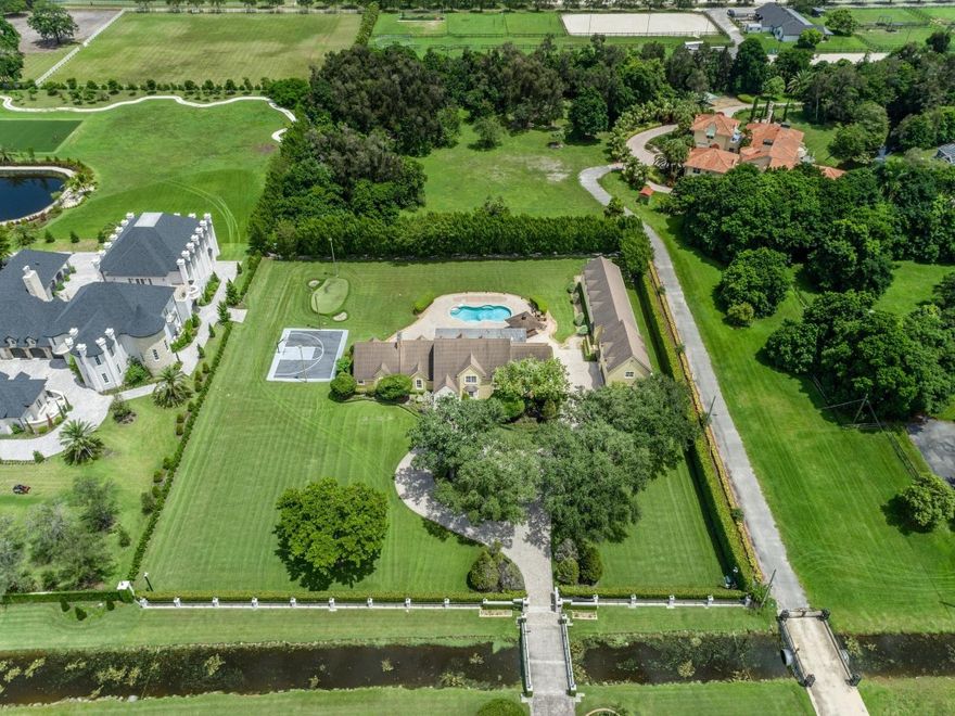 ONE OF A KIND PROPERTY LOCATED ON PREMIER STREET HANCOCK ROAD SITTING ON 1.8 ACRES. THIS HOME IS SCREAMING CURB APPEAL. MAIN HOUSE IS 4 BEDROOM PLUS 1 BEDROOM GUEST HOUSE. 4 CAR GARAGE LARGE MOTOR COURT. WONDERFUL ROOF VERANDA FOR ENTERTAINING, FABULOUS SUMMER KITCHEN, CUSTOM POOL. ALL THIS AND MORE, SPECIAL BONUS. AIR CONDITIONED 1,000 SQFT BUILDING COULD BE USED FOR MULTI-PURPOSE ETC..