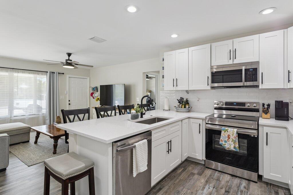 Turnkey! Fully renovated 3-bedroom, 2-bath single family home steps from downtown Lake Worth. Enjoy the convenience of city life with a backyard and floor plan made for the suburbs. The property was completely remodeled less than three years ago. The open kitchen features quartz counters, white Shaker cabinets and stainless-steel appliances. Luxury vinyl plank flooring throughout. No carpet. Split bedroom layout. Large master bedroom and walk-in closet. Stylishly renovated bathrooms. Practical, not just luxurious. Complete impact windows, tankless water heater and upgraded plumbing. No cast iron! New W/D Updated electrical and breaker panel. Immense backyard with room for a pool or Tiki bar. Steps from restaurants, nightlife and entertainment. Bike to the beach. Call now.