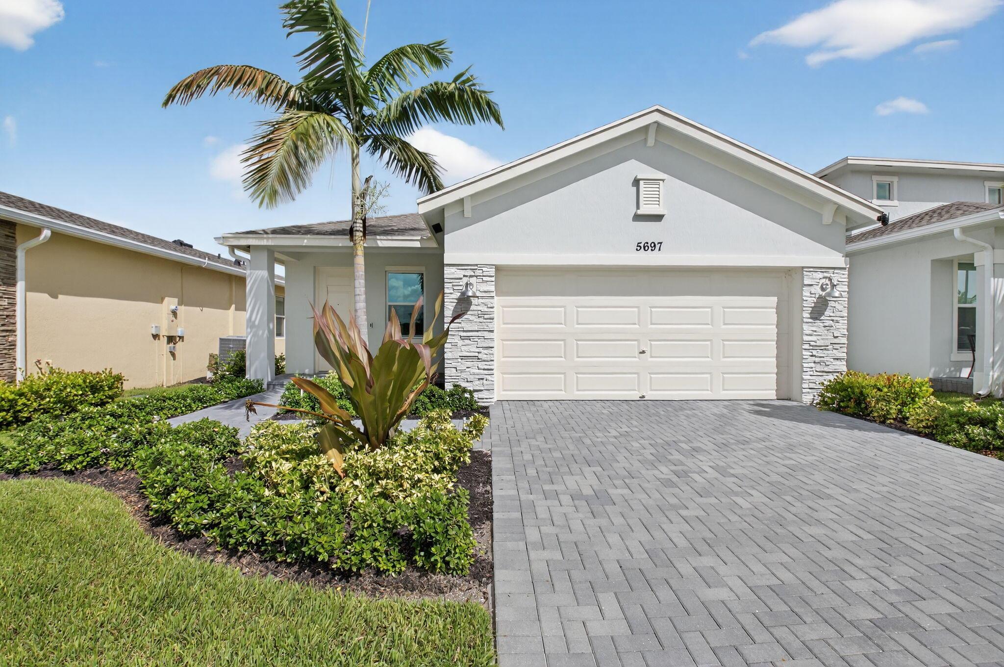 Rare Lakefront Gem in Delray Trails!Welcome to 5697 Graceful Way, a 2024 new construction home on a premium lakefront lot in Delray Beach's newest 55+ community. This move-in ready residence offers 3 bedrooms, 2 bathrooms, and an open concept design filled with natural light from full impact windows. The modern kitchen boasts quartz counters, stainless steel appliances, and an island with lake views. Upgrades include tile flooring throughout (no carpet) and epoxy garage flooring.Community highlights: low HOA, gated entry, lawn care, and incredible planned amenities--clubhouse with cafe/bar, resort pool, fitness center, pickleball, walking trails, and social events.Unbeatable location: just minutes to Atlantic Avenue, beaches, golf, dining, shopping, and medical facilities