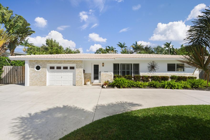 Live the Florida lifestyle in this beautifully updated Lighthouse Point home! Featuring an open, airy layout with modern finishes, this home is move-in ready with an updated kitchen (2023), both bathrooms (2025),  2021 HVAC, 2024 impact windows/doors, and a 2026 refinished pool with new glass tile and Diamond Brite. Enjoy 3 spacious bedrooms + a versatile 4th bedroom (converted garage, easily reverted to 1-car garage). The lush backyard and covered patio are designed for effortless entertaining. Located near the marina, dining, and shopping, you are just minutes from the sand! Buyer Agents welcome. PRICED TO SELL.