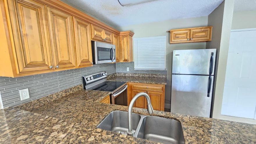 Ready to Move In or rent right away. Second floor,  2-bedrooms & 2 baths condo, featuring modern kitchen with granite countertop and stainless steel appliances. and a bright, clean interior. Unit offers easy access and a functional layout, perfect for year-round living or seasonal enjoyment. Conveniently located in West Palm Beach, close to shopping, dining, and major roadways.