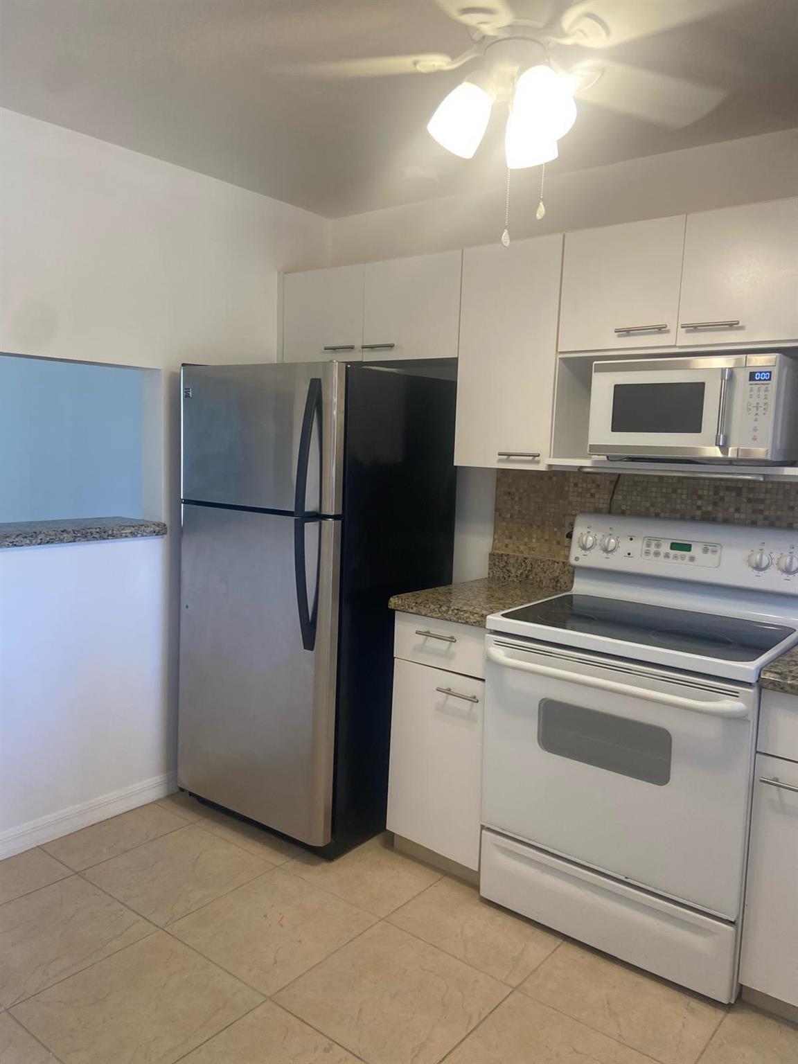 Second floor cozy, bright and renovated unit. You must see to appreciate this beautiful kitchen with white appliances and granite countertops., newer AC and water heater. Screened patio, white floors, large recently renovated shower, walk-in closets, lots of space, large power room with a window, large and bright living/dining room. Located just a few steps from the elevator. The community pool is very close to the unit, large clubhouse with tennis courts, spa, large gym and lots of other features.