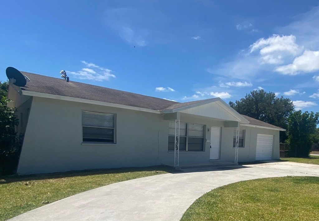 Photo of 644 Date Palm Drive, Lake Park, FL 33403 (MLS # R10984217)