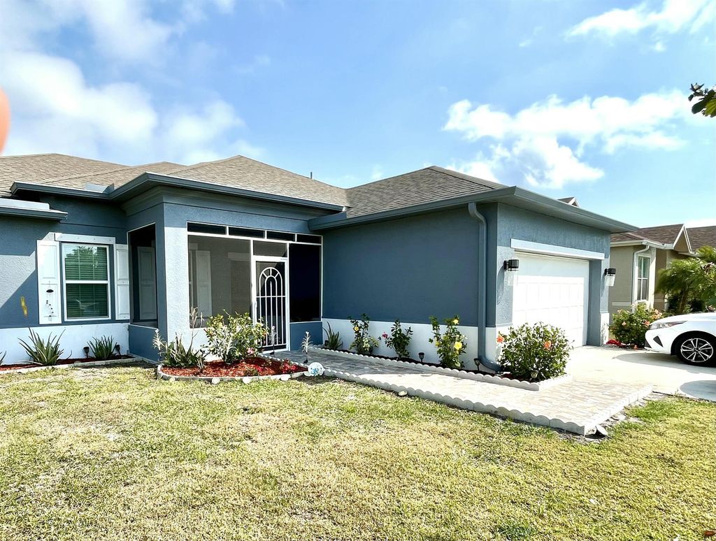 Photo of 701 SW Mccomb Avenue, Port Saint Lucie, FL 34953 (MLS # R11071327)