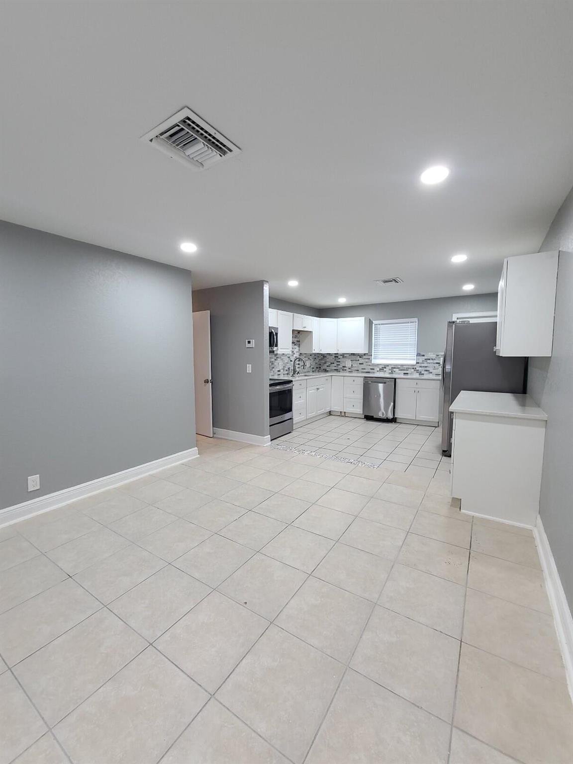 Experience modern living in this fully renovated 3-bedroom, 1-bathroom apartment featuring tile flooring throughout. The open-concept kitchen boasts a sleek, contemporary design with stainless steel appliances. Enjoy the convenience of a private laundry room with a full-size washer and dryer. The bathroom has been tastefully updated, and the central A/C system is just 3 years old. Additional highlights include decorative ceiling fans in each room. Located just one block from Martin Luther King Blvd and minutes from I-95, offering easy access to major roads and local amenities.