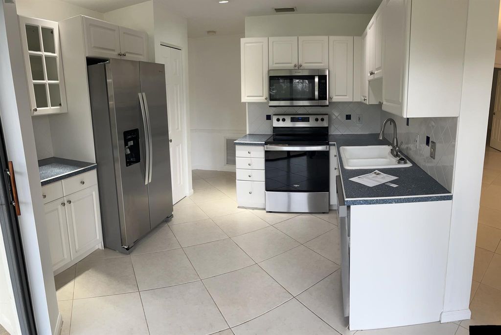 Photo of 7 Lexington Lane E #A, Palm Beach Gardens, FL 33418 (MLS # R11062201)