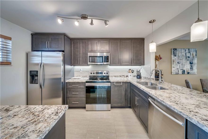 Spectacular spacious 1260 feet 2 bedrooms, 2 bathrooms updated condo. Updated open kitchen. Wood cabinets. Granite counter top. Tiled backsplash. Stainless appliances. Porcelain tile flooring throughout. Full size washer & dryer in the unit. Fully furnished ready to move in with new modern furniture. IMPACT WINDOWS. Spacious master bedroom with 2 walk-in closets. 2 updated bathrooms. Large private screened patio overlooking a relaxing tropical landscaping and pool area view. New custom solar shades for the patio door. Welcome to the 18th Hole 24/7 gated active 55+ community. Offers Tennis courts, heated pool, clubhouse. BBQ area & much more. Great location minutes to shopping & restaurants. Per Association 710 credit, $45k income, 6 months maintenance in escrow & requires 20% down w/offer.